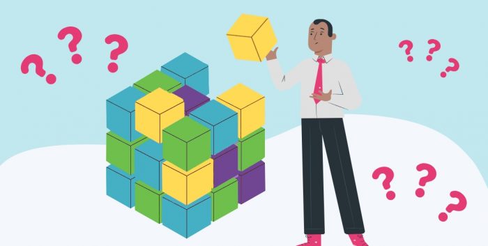 business man holding a rubix cube